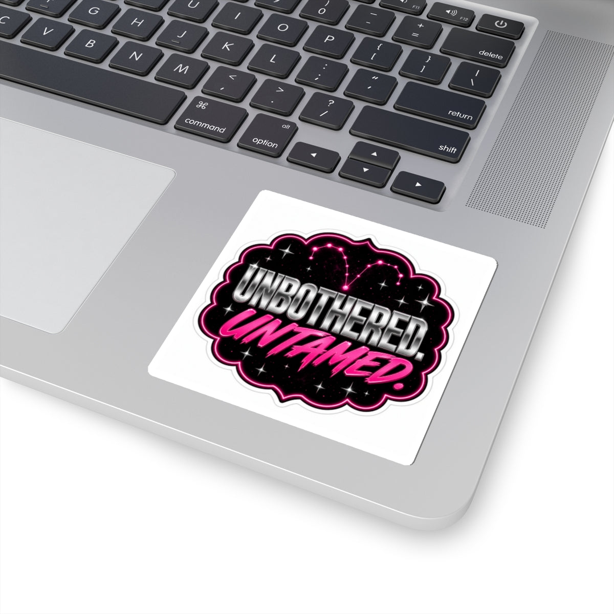 A kiss-cut sticker featuring the "Unbothered. Untamed." Aries design on paper with bold black text and artistic details.